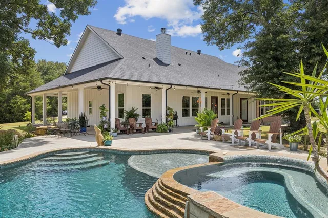 a view of a house with sitting area and swimming pool