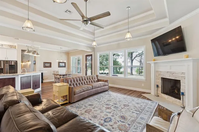a living room with furniture a flat screen tv and a fireplace