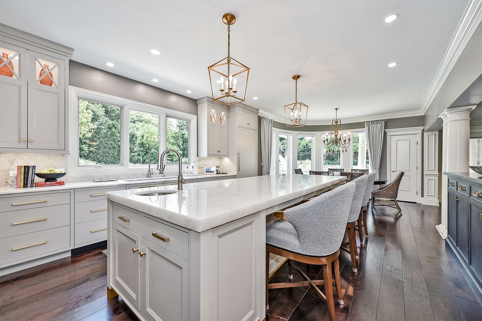 1877 Banbury Road Inverness, IL 60067 - Photo 11 of 59 a kitchen with kitchen island a dining table chairs sink and wooden floor