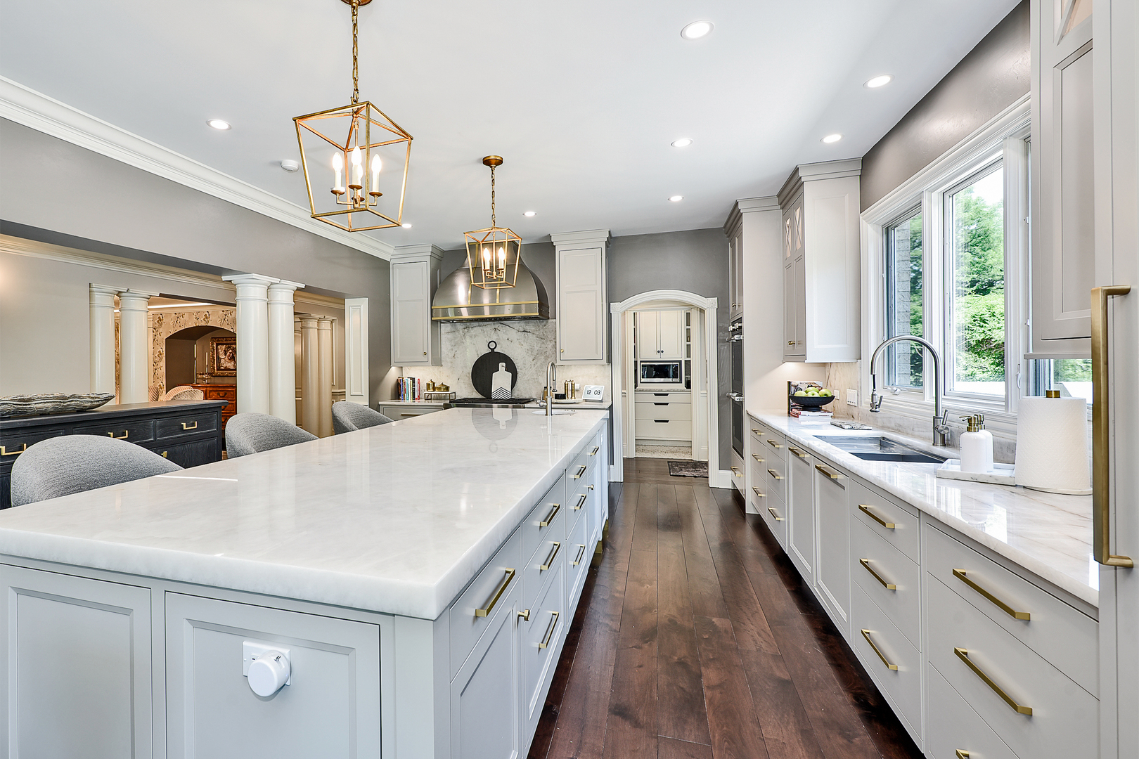 1877 Banbury Road Inverness, IL 60067 - Photo 12 of 59 a large white kitchen with a large window a sink and stainless steel appliances