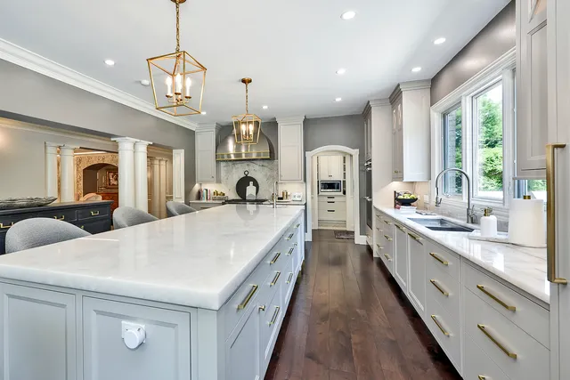 a living room with furniture a fireplace and lots of windows