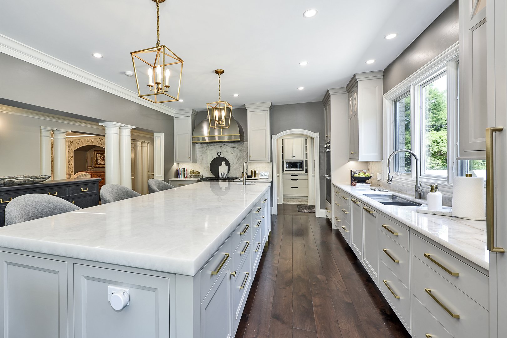 1877 Banbury Road Inverness, IL 60067 - Photo 12 of 59 a large white kitchen with a large window a sink and stainless steel appliances