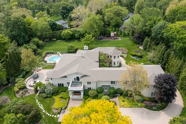 an aerial view of a house with garden space and street view