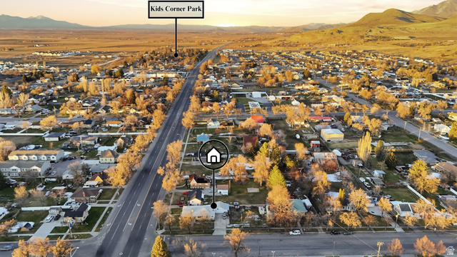 202 Main Street Smithfield, UT 84335 - Photo 31 of 32 Aerial view of property and surrounding area featuring a mountain backdrop and nearby suburban area