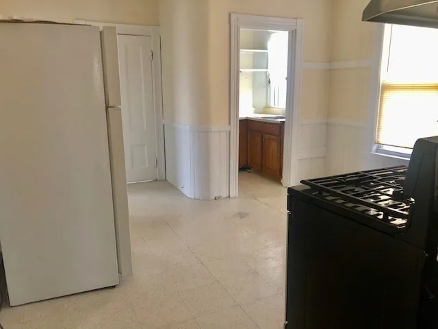 a kitchen with a stove a sink and a window