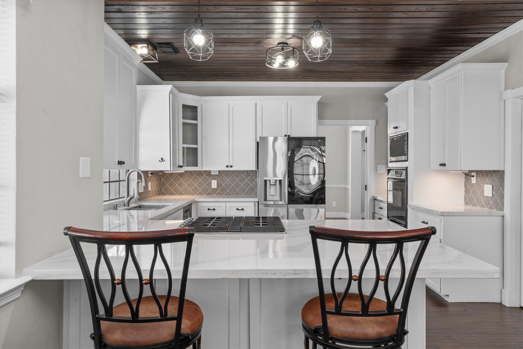 10402 Hondo Hill Road Houston, TX 77064 - Photo 15 of 40 a kitchen with stainless steel appliances granite countertop a dining table chairs and a refrigerator