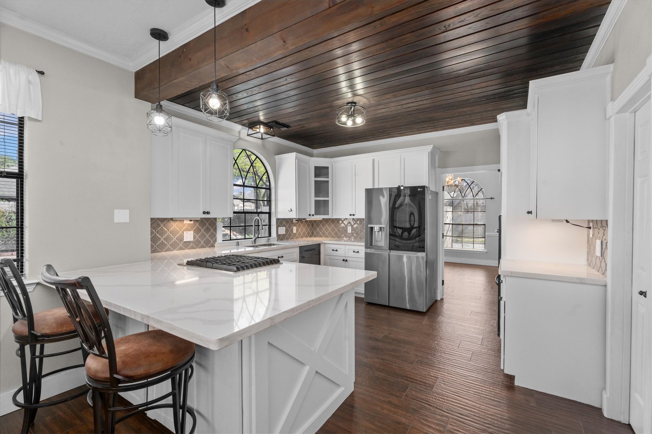 10402 Hondo Hill Road Houston, TX 77064 - Photo 16 of 40 a kitchen with stainless steel appliances granite countertop a table chairs and a refrigerator
