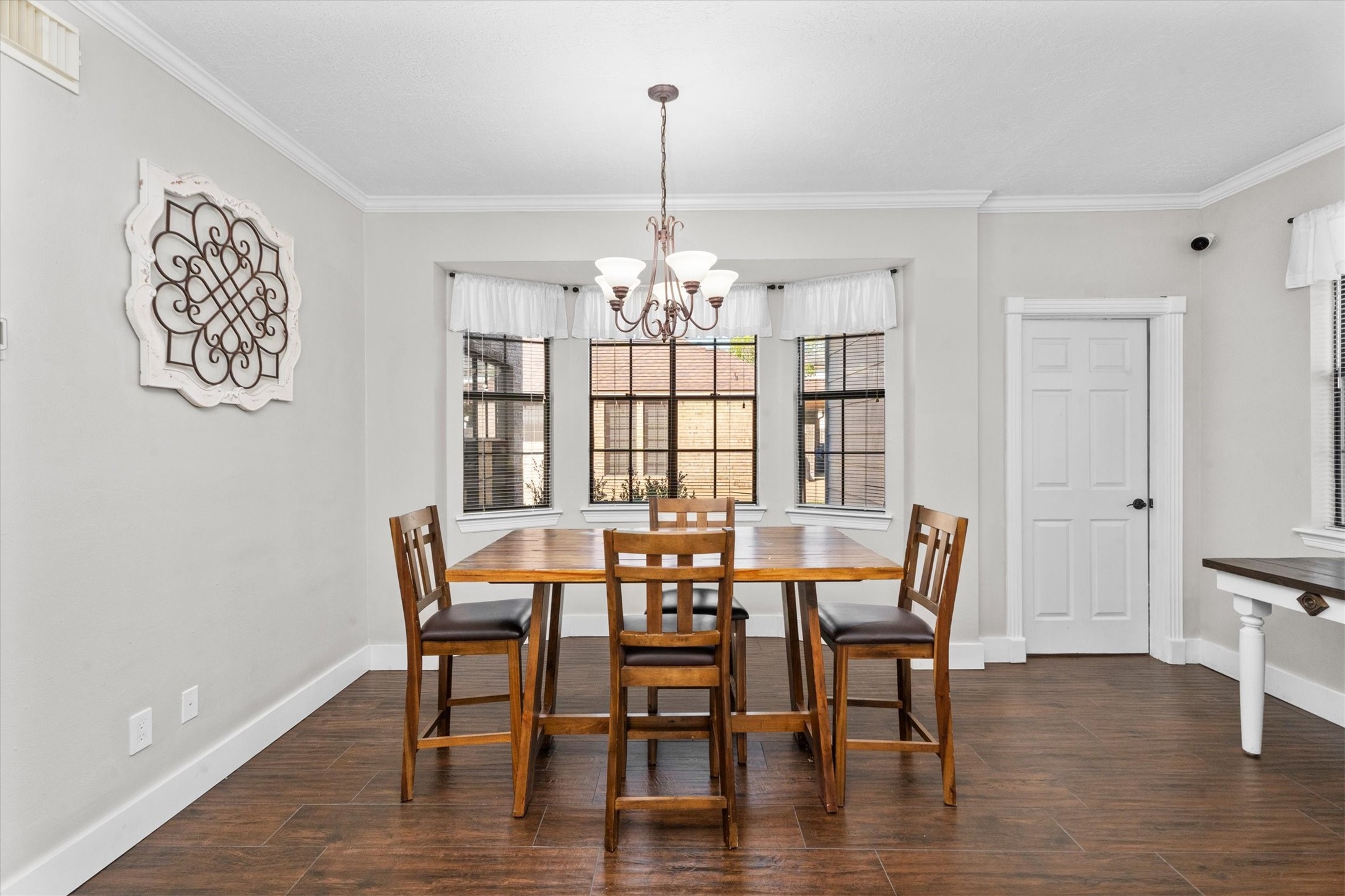 10402 Hondo Hill Road Houston, TX 77064 - Photo 18 of 40 a view of a dining room with furniture wooden floor and chandelier