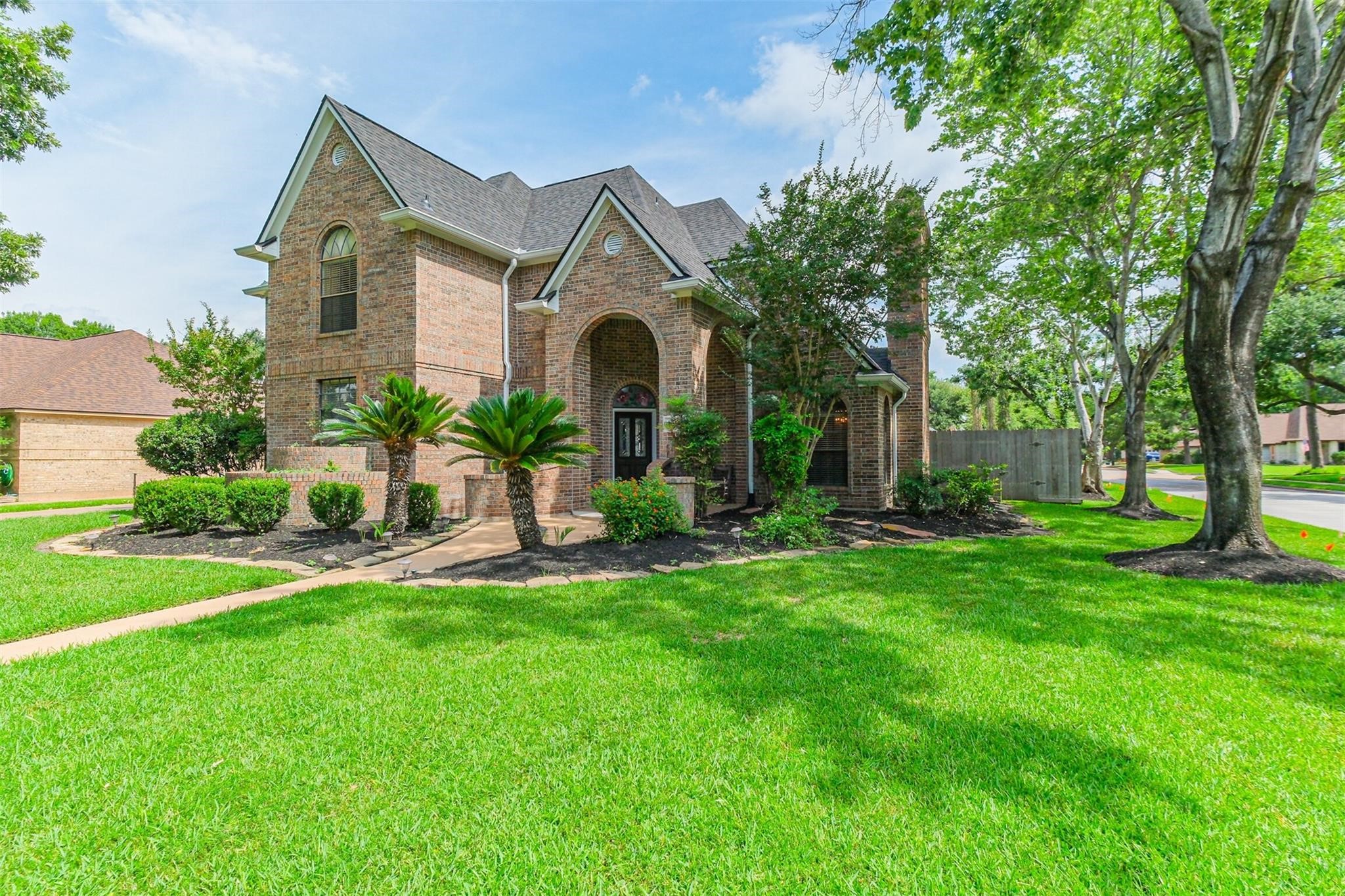 10402 Hondo Hill Road Houston, TX 77064 - Photo 2 of 40 a front view of a house with a yard and garage
