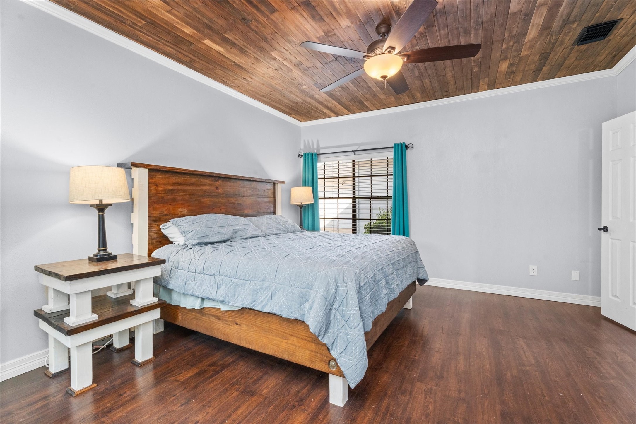10402 Hondo Hill Road Houston, TX 77064 - Photo 21 of 40 a bedroom with a bed window and a chandelier