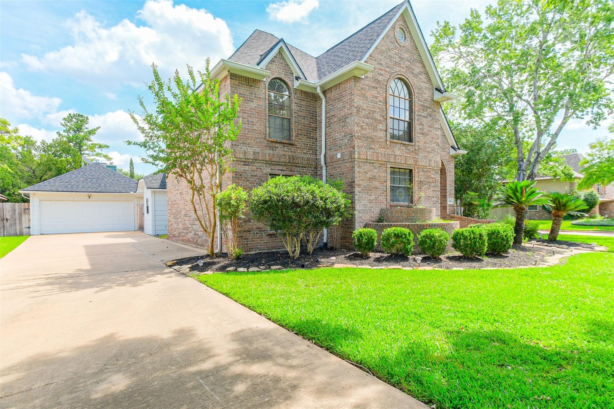 10402 Hondo Hill Road Houston, TX 77064 - Photo 3 of 40 a front view of a house with a yard and garage