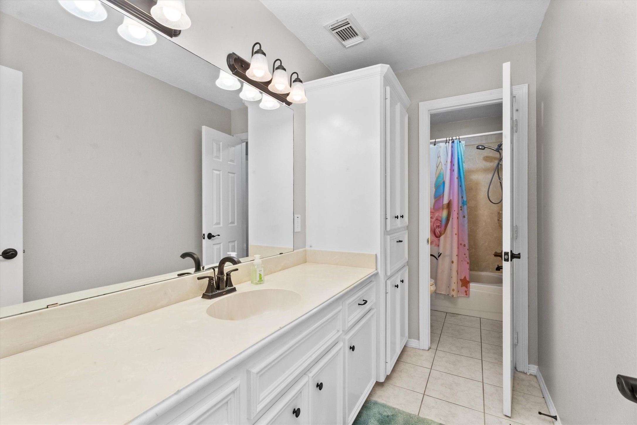 10402 Hondo Hill Road Houston, TX 77064 - Photo 31 of 40 a bathroom with a sink a vanity and a mirror