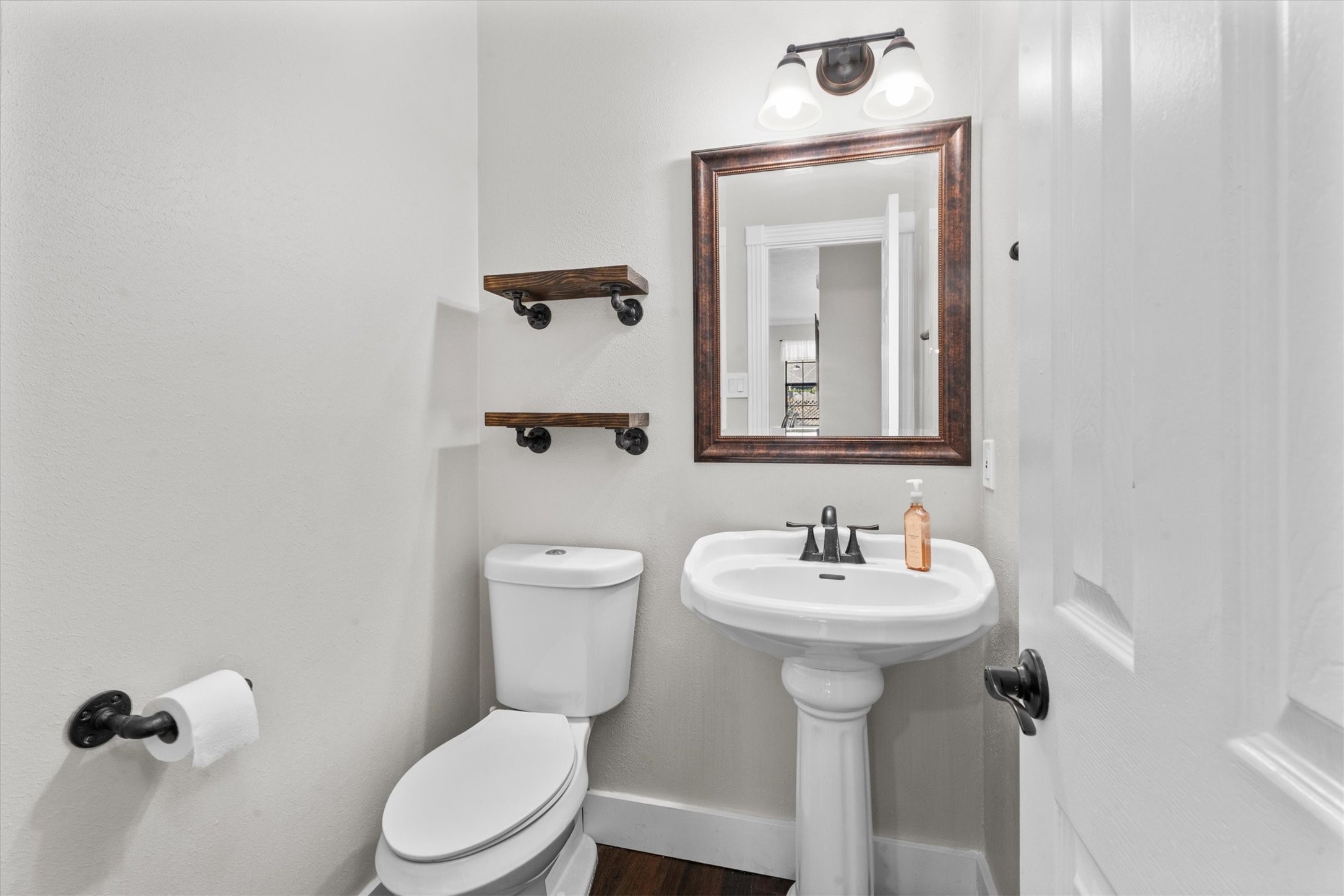 10402 Hondo Hill Road Houston, TX 77064 - Photo 34 of 40 a bathroom with a toilet sink and mirror