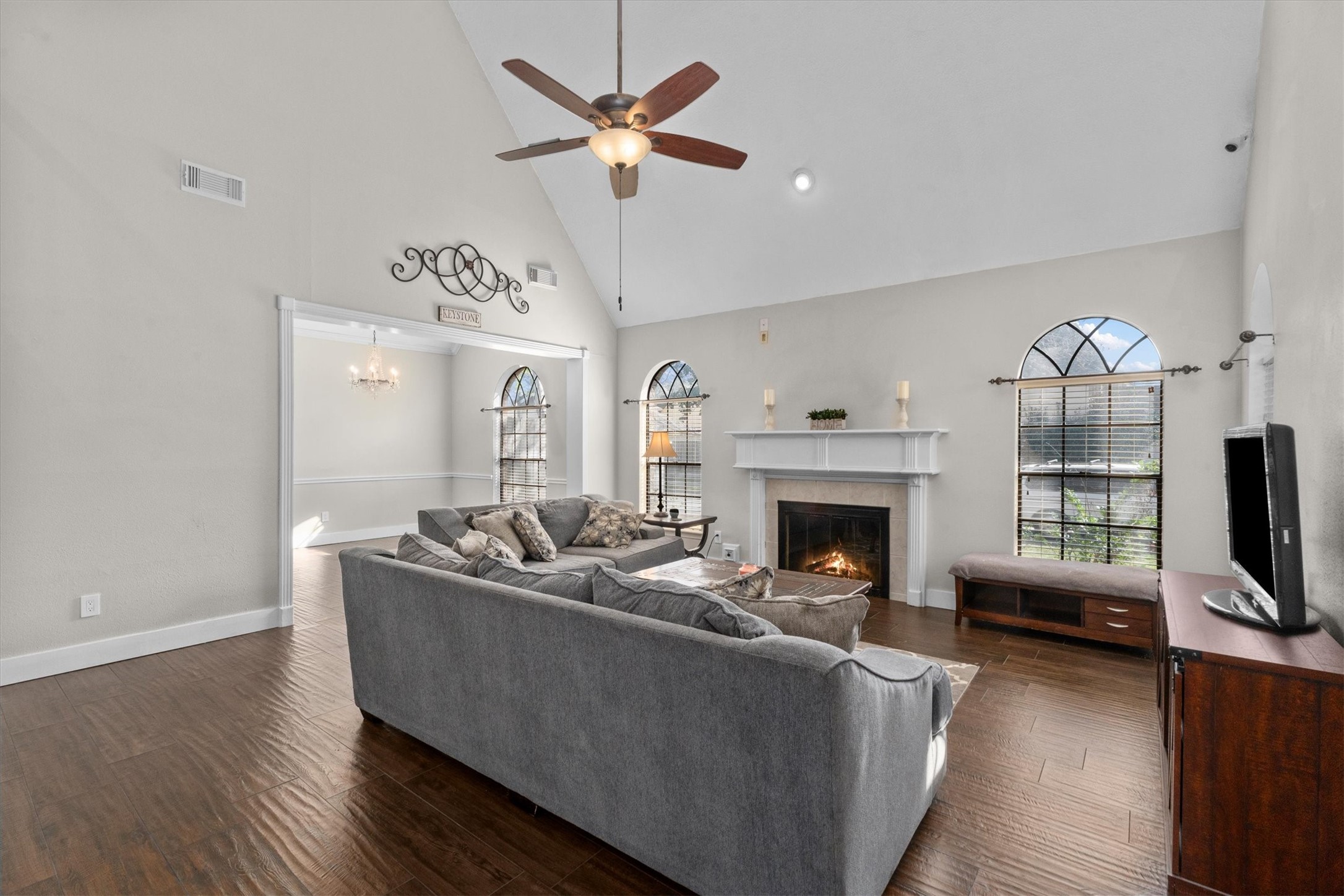 10402 Hondo Hill Road Houston, TX 77064 - Photo 9 of 40 a living room with furniture a fireplace and a flat screen tv