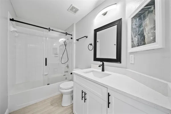 a bathroom with a toilet sink and shower