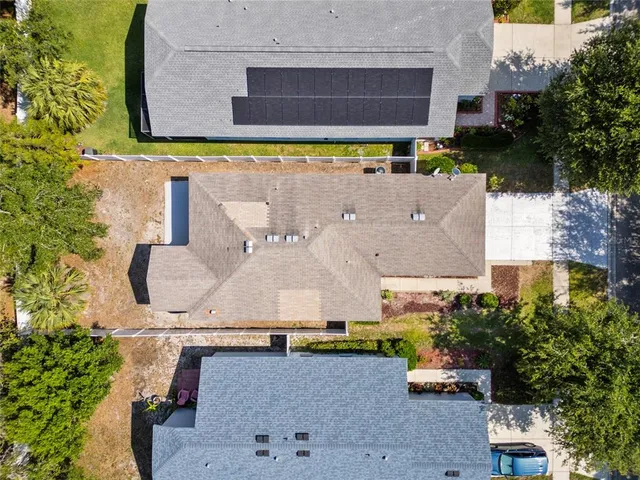 an aerial view of a house with a yard and pool