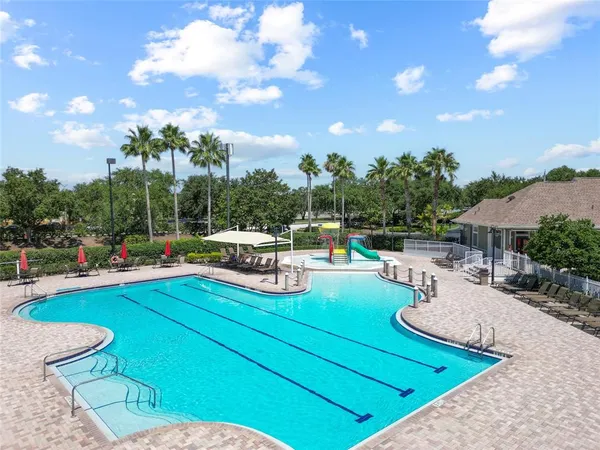 a view of a house with swimming pool and furniture