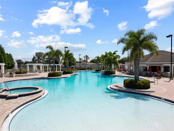 a view of a swimming pool with lounge chairs