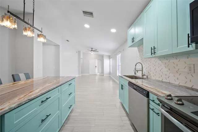 a kitchen with granite countertop a sink and a stove