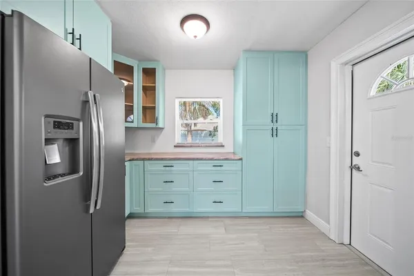 a kitchen with stainless steel appliances granite countertop a refrigerator and a stove