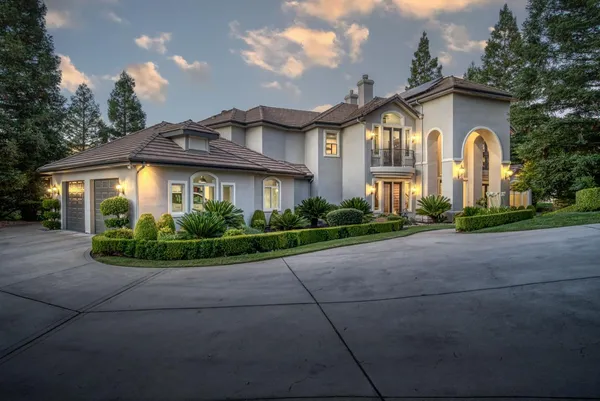 a front view of a house with a garden