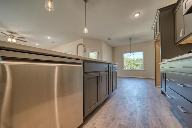 a kitchen with a sink and chandelier