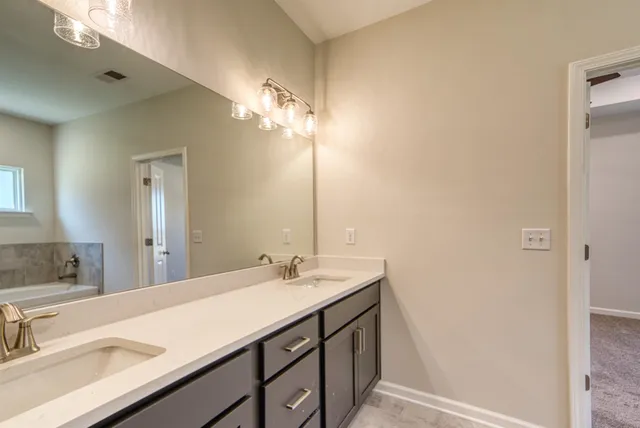 a kitchen with stainless steel appliances wooden floor sink and wooden cabinets