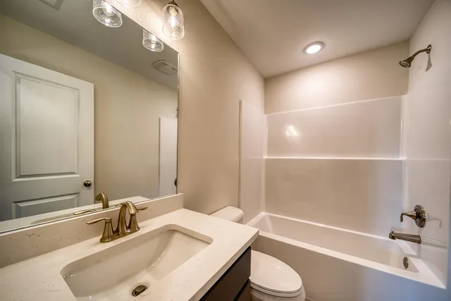 a view of a hallway with wooden floor and entryway