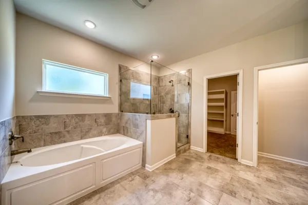 en empty room with windows and fan