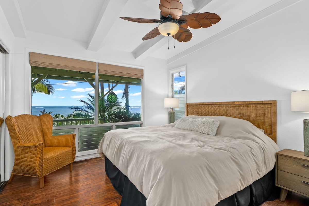 4271 Anini Road Princeville, HI 96722 - Photo 12 of 24 a bedroom with a large bed couch and a large window