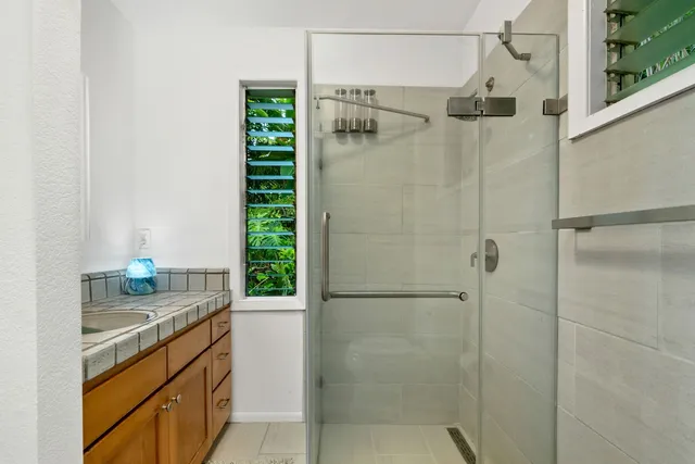 a bathroom with a shower and a sink