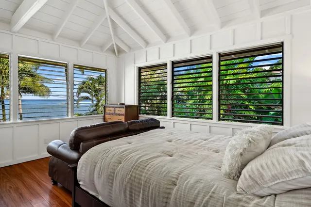 a bedroom with a large bed and a large window