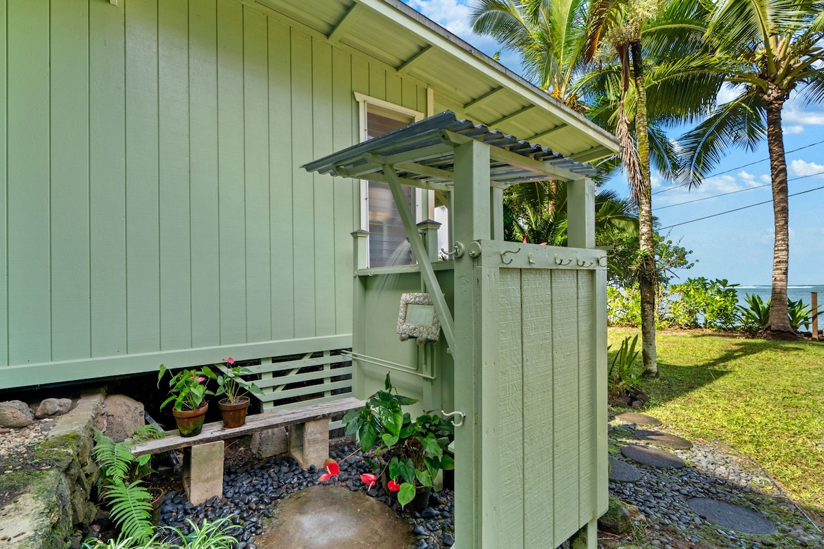 4271 Anini Road Princeville, HI 96722 - Photo 23 of 24 a backyard of a house with wooden fence and a toy car