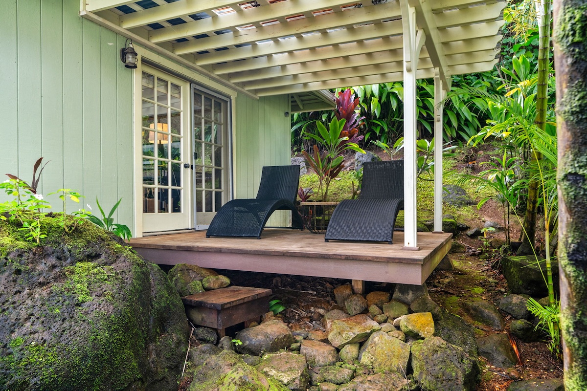4271 Anini Road Princeville, HI 96722 - Photo 24 of 24 a vase of flowers sitting on a table in front of a house