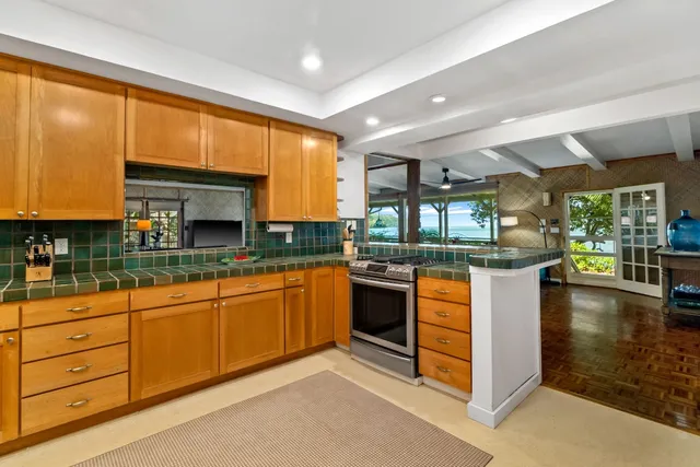 a kitchen with stainless steel appliances granite countertop a sink and cabinets