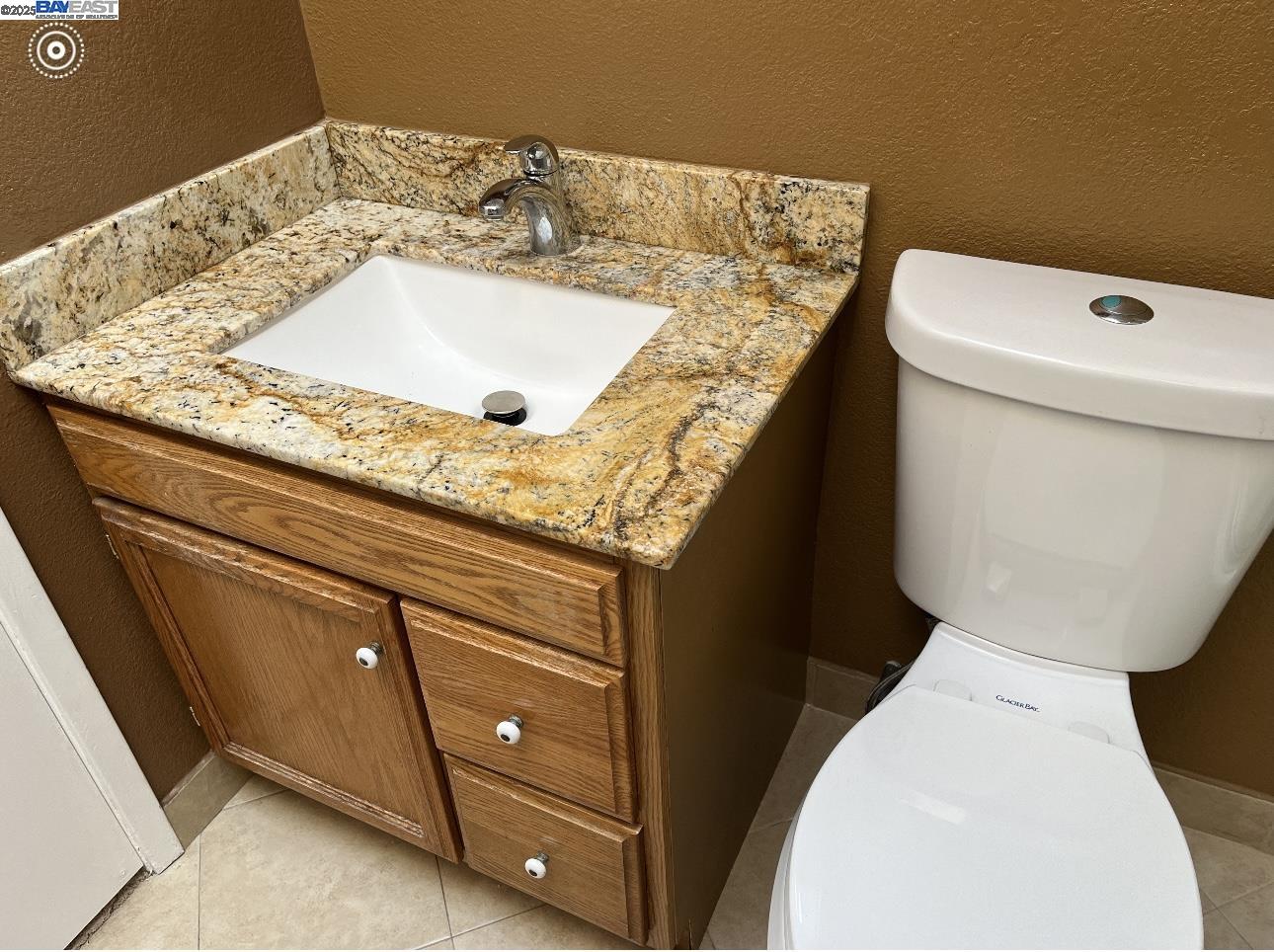 117 Day Street, Unit 204 San Francisco, CA 94131 - Photo 12 of 20 a bathroom with a granite countertop sink and a toilet