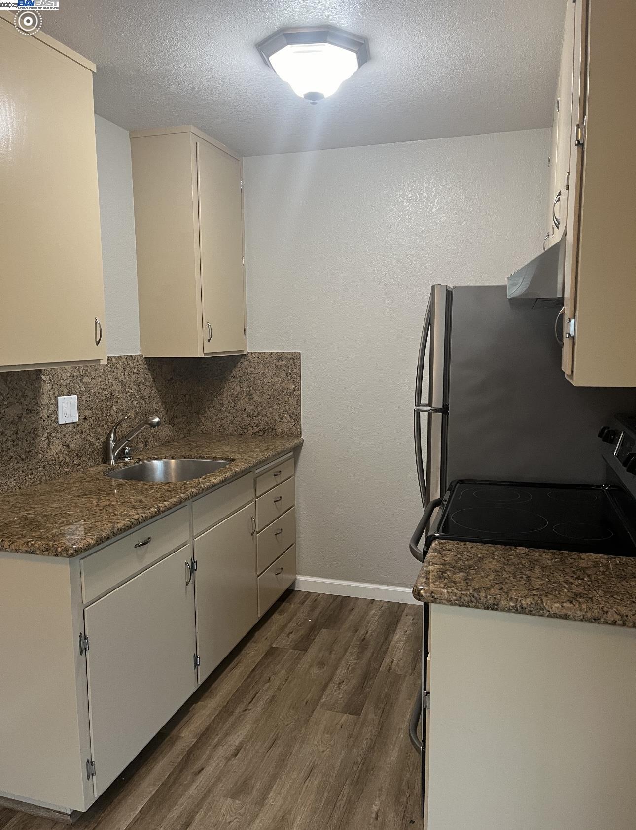 117 Day Street, Unit 204 San Francisco, CA 94131 - Photo 17 of 20 a kitchen with stainless steel appliances granite countertop a sink stove and refrigerator