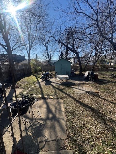 1934 Calypso Street Dallas, TX 75212 - Photo 11 of 11 a backyard of a house with table and chairs under an umbrella