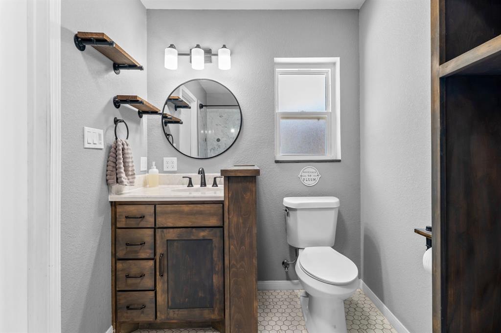 373 Ingred Street Waco, TX 76705 - Photo 15 of 39 a bathroom with a toilet a sink and a mirror