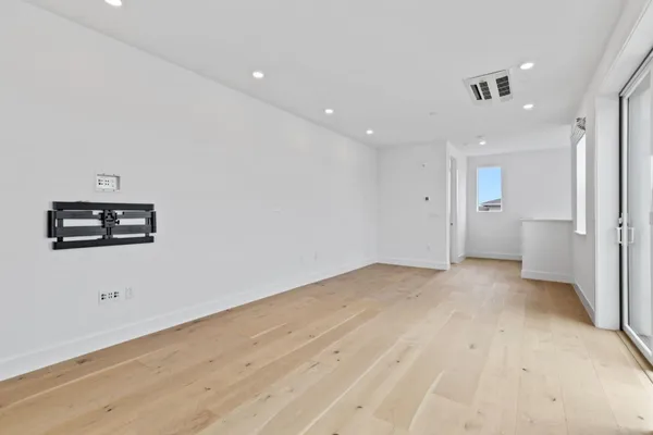a view of empty room with a kitchen