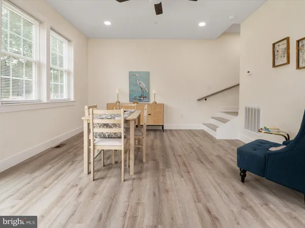 a dining room with furniture and wooden floor