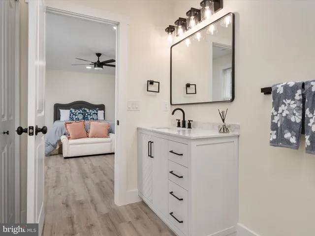 a bathroom with double vanity sink and mirror