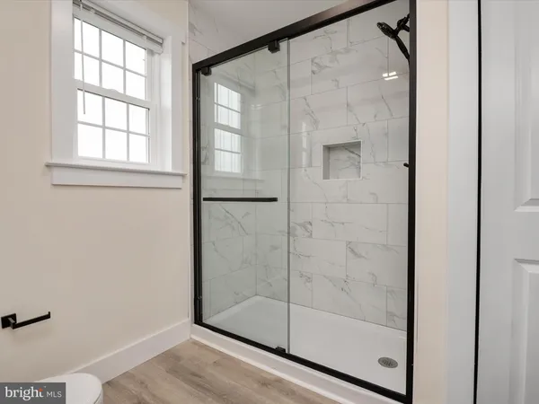 a bathroom with a glass shower door