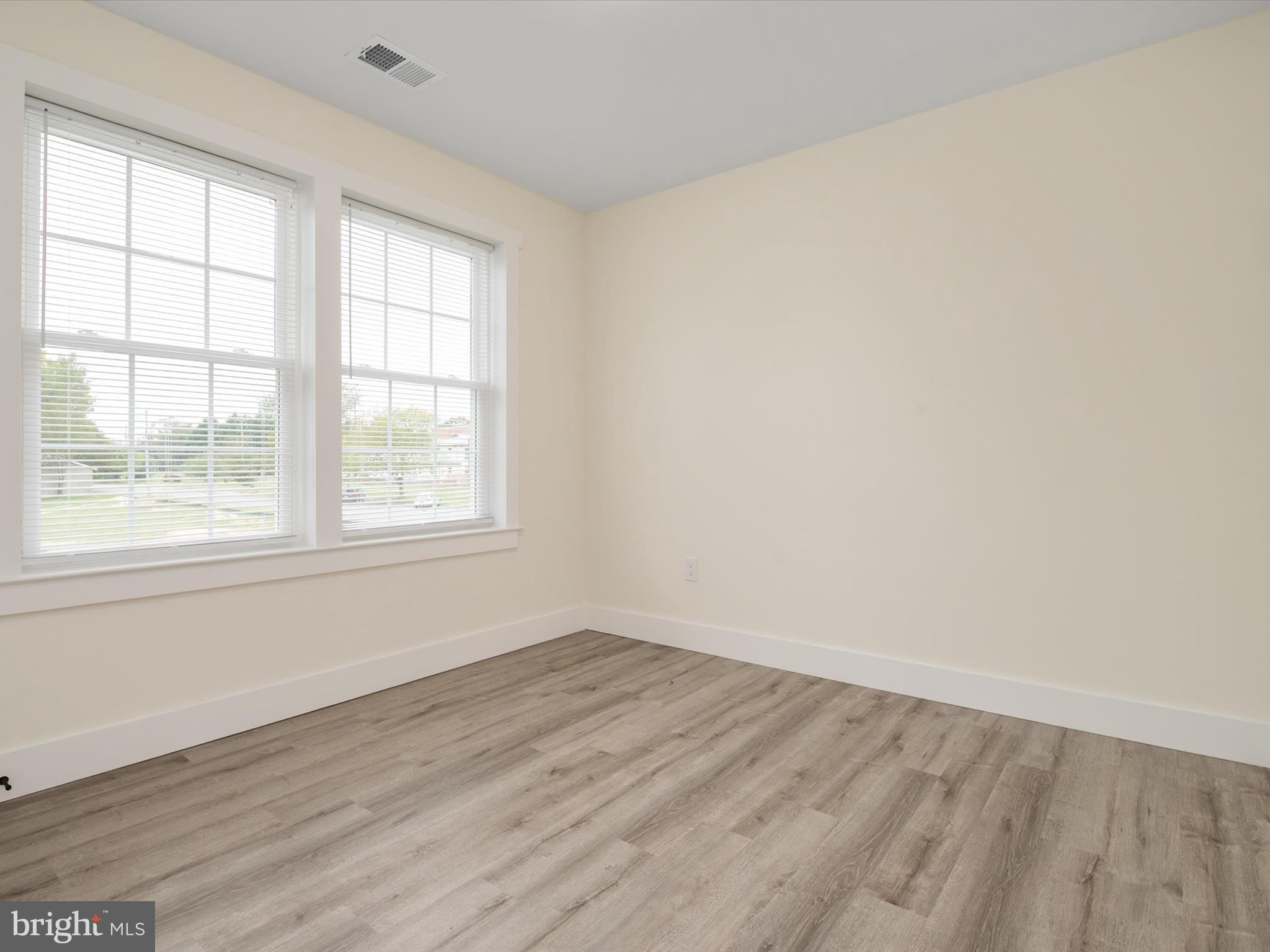 1 Sunrise Avenue Ridgely, MD 21660 - Photo 22 of 28 an empty room with wooden floor and windows