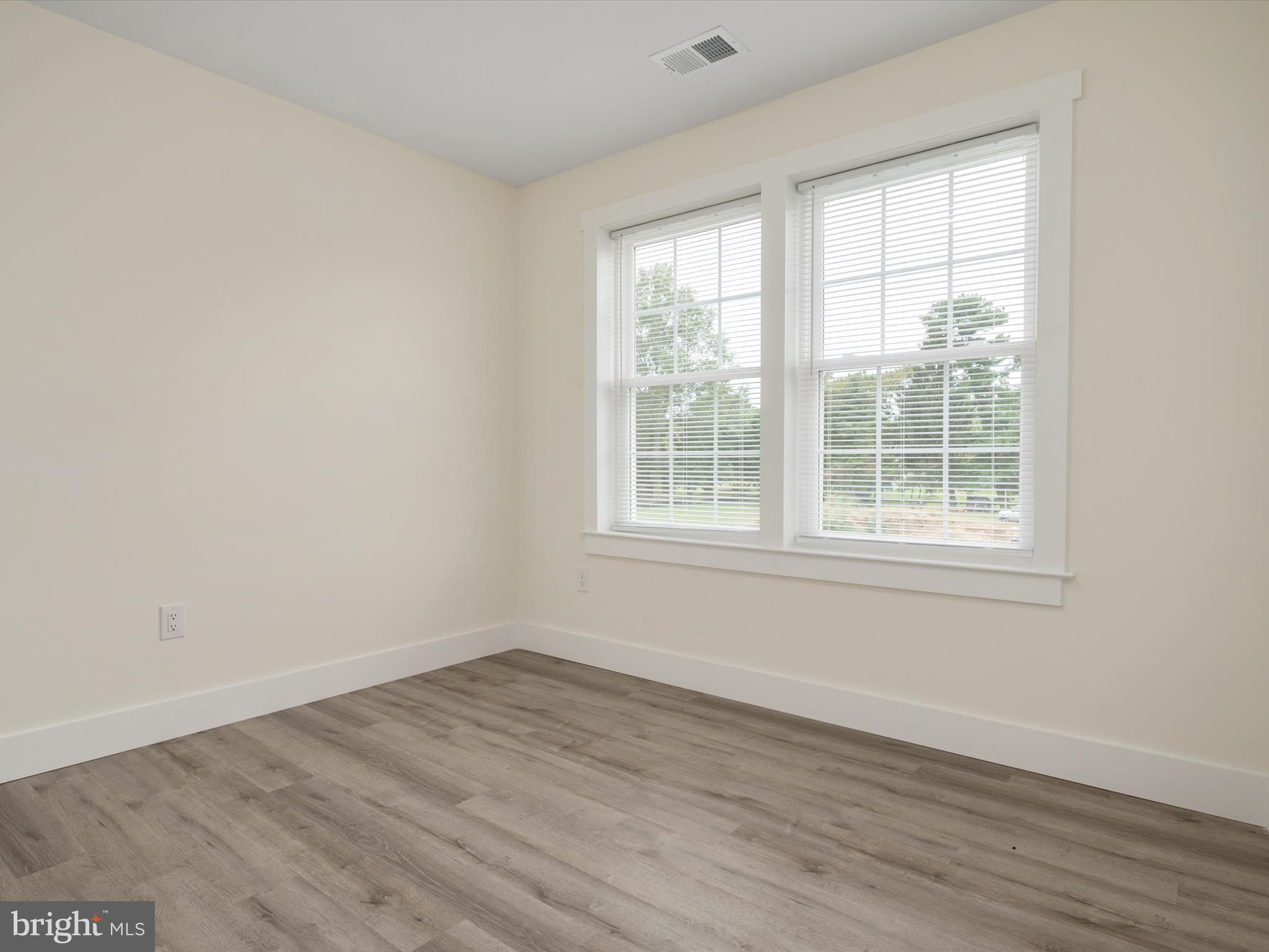 1 Sunrise Avenue Ridgely, MD 21660 - Photo 24 of 28 an empty room with wooden floor and windows