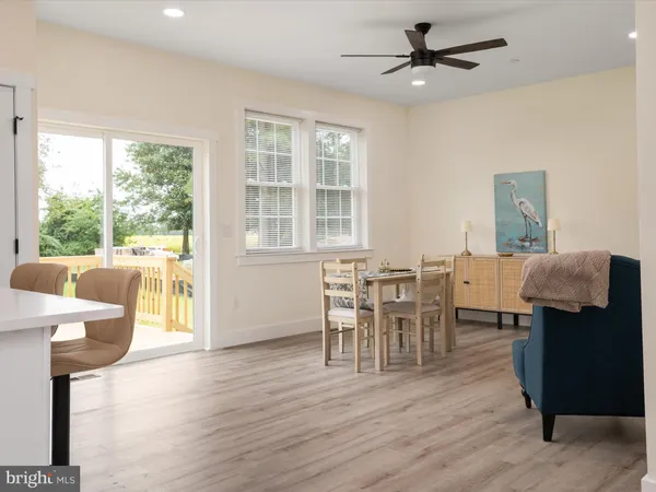 a dining room with furniture and wooden floor