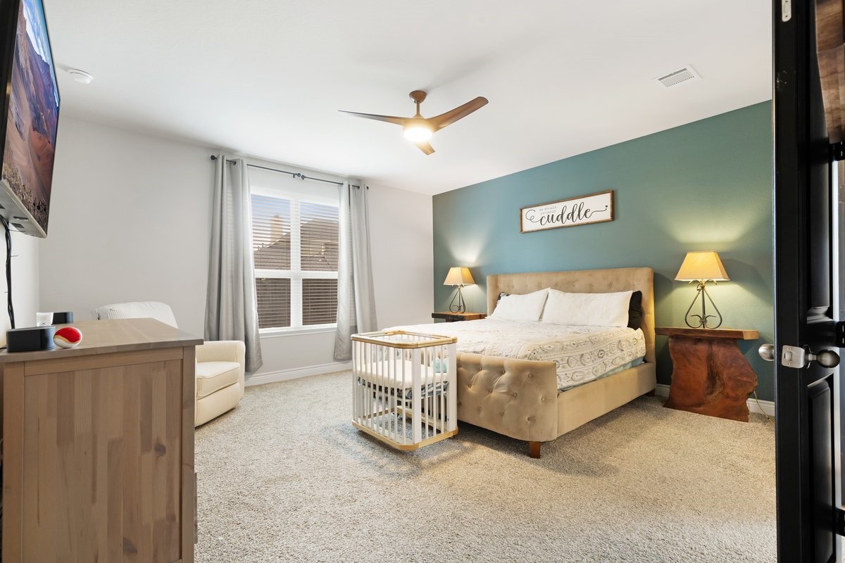 15815 Gibson Grass Court Spring, TX 77379 - Photo 12 of 25 a spacious bedroom with a bed and a large window