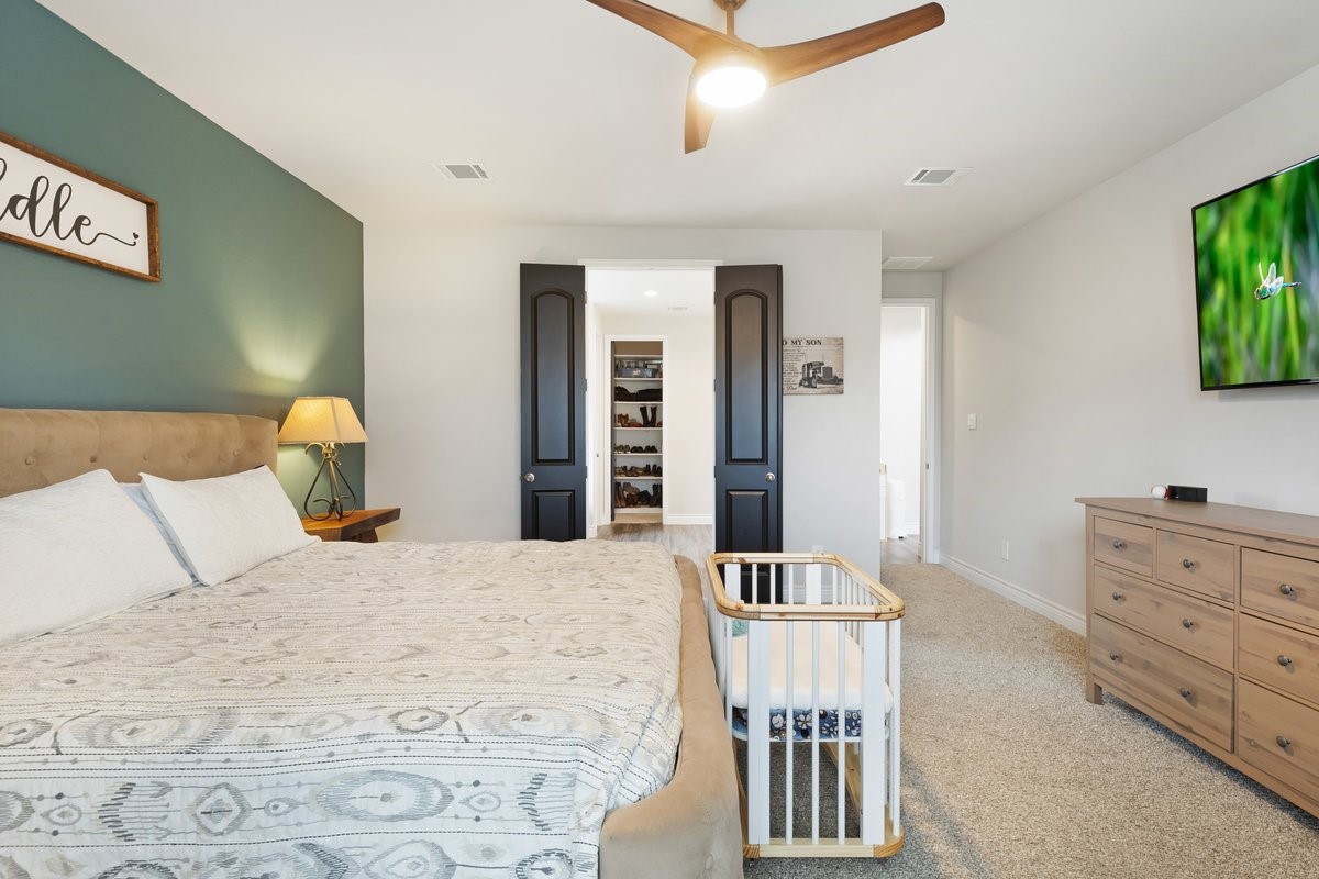 15815 Gibson Grass Court Spring, TX 77379 - Photo 13 of 25 a bedroom with a bed and wooden floor
