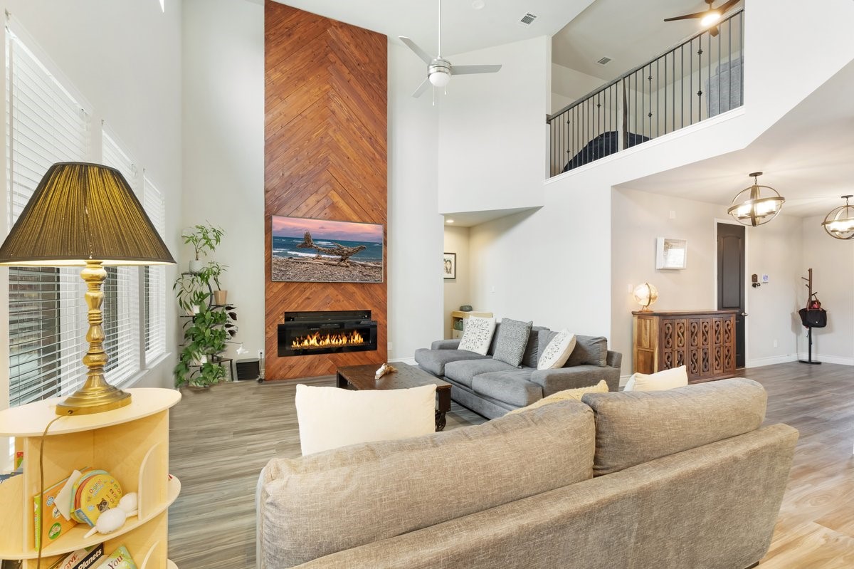 15815 Gibson Grass Court Spring, TX 77379 - Photo 5 of 25 a living room with furniture a fireplace and a chandelier