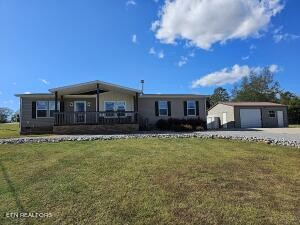 211 North Springview Road Maryville, TN 37801 - Photo 1 of 27 a front view of a house with a garden